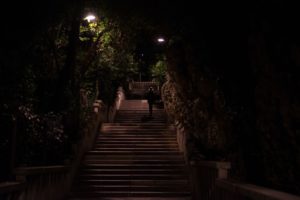 A dimly lit outdoor staircase poses a potential falling hazard