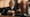 A blurred image of a judge with a gavel in a courtroom.