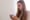 A concerned woman reading a pill bottle.