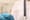 Doctor holding T-shaped intrauterine birth control device on blurred background, closeup.