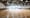 Blurry image of an empty indoor basketball court.