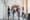 College students walking through a university campus hallway.