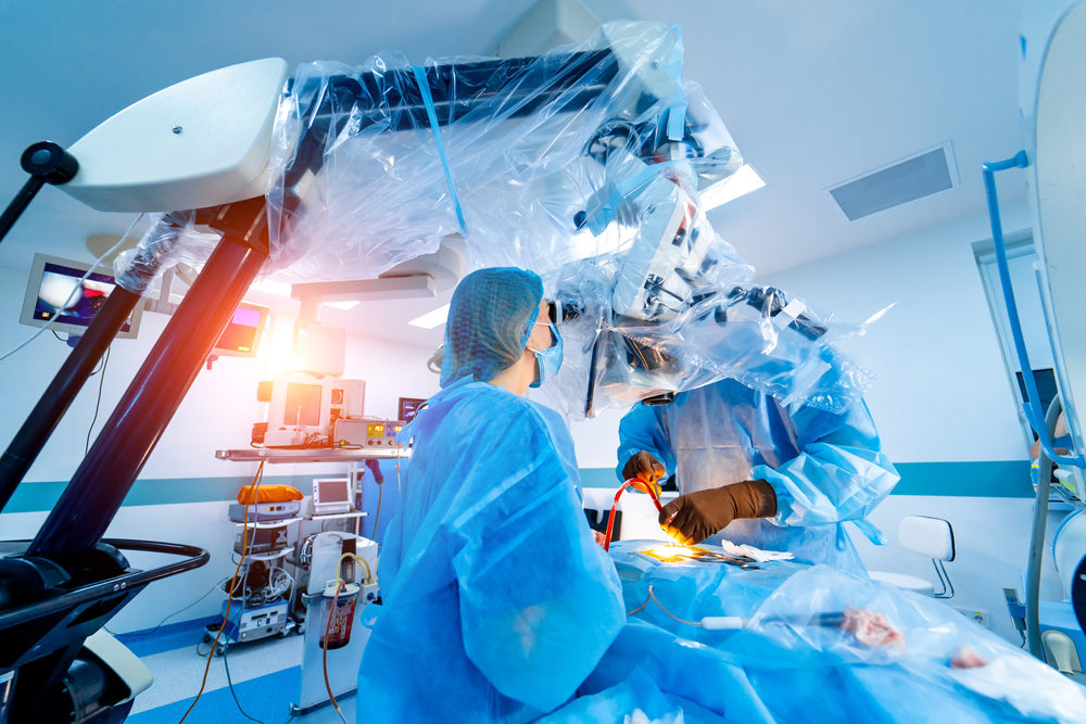 Surgeons in medical uniform and masks working in the operating room. 