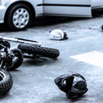 Helmet and motorcycle on the street after car crash