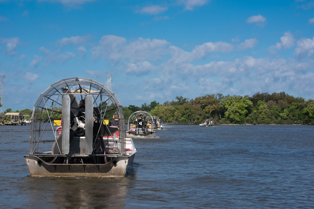 Airboats with tourists leaving on guided tour through Louisiana swamps