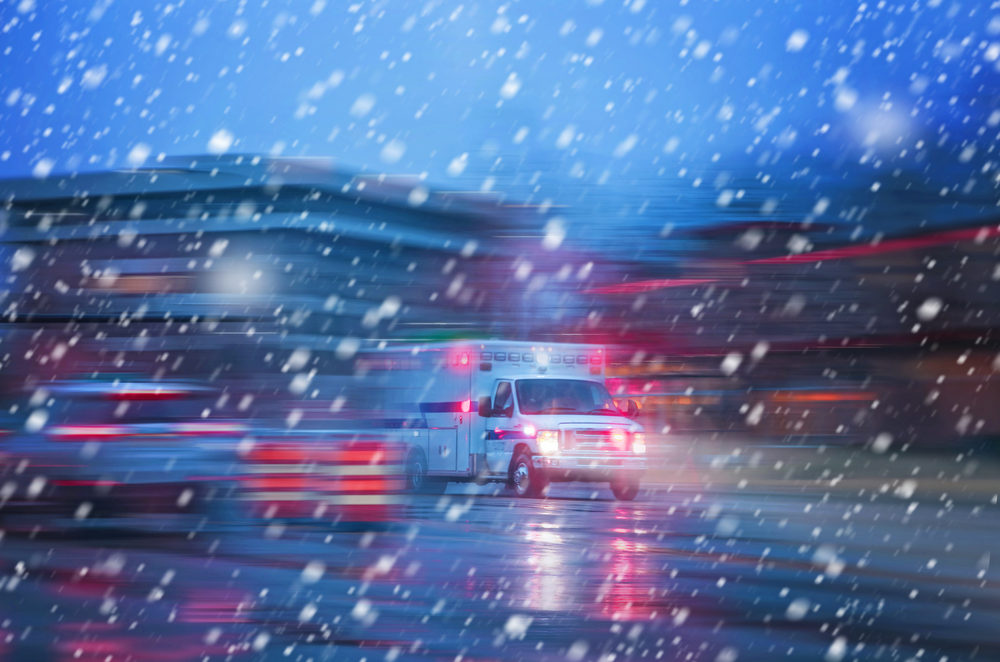 an ambulance racing through the rain on a stormy night with motion blur