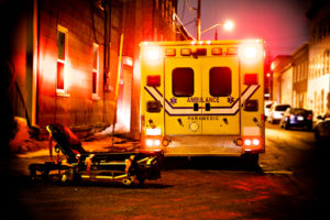 An ambulance car parked on the side street at night