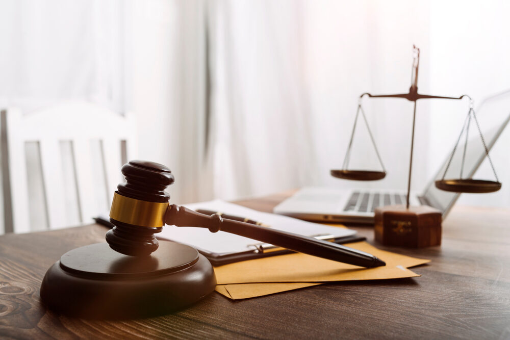 Attorney's desk with a laptop gavel and scales