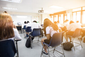 back view of students at desks in classroom