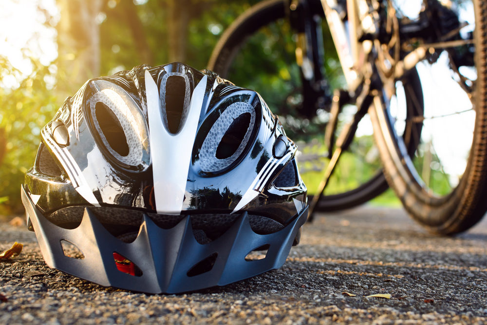 Bike helmet and bike on the street and evening sun