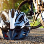 Bike helmet and bike on the street and evening sun