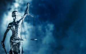 lady justice statue closeup with a blue blurred background