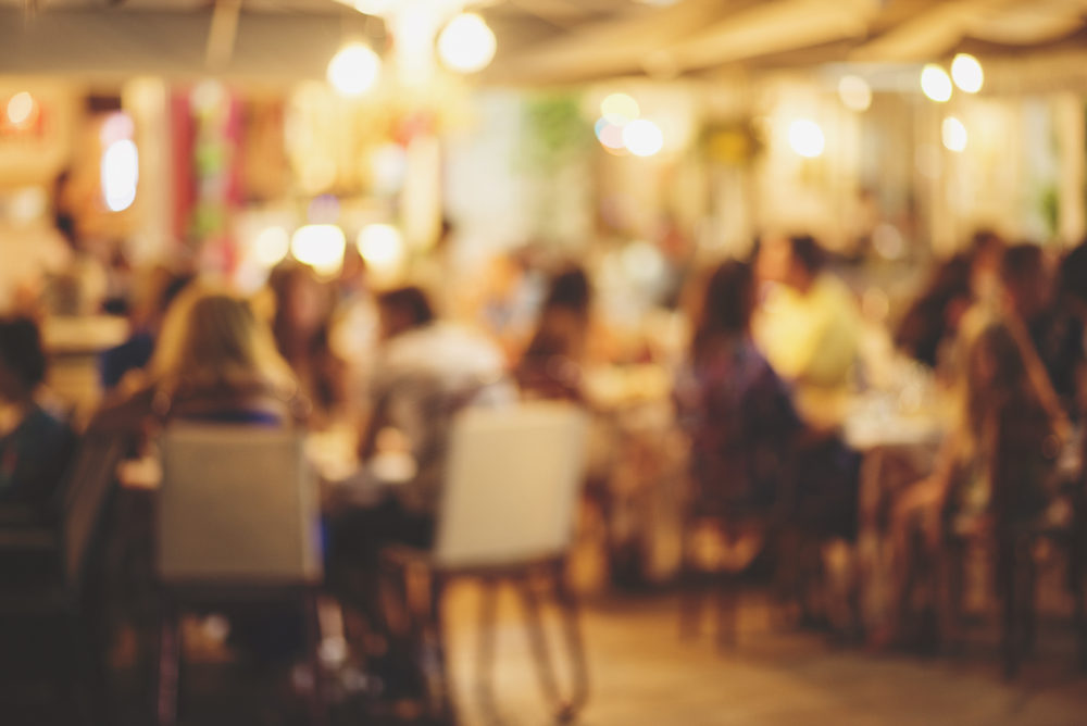 blurred restaurant with patrons seated dining