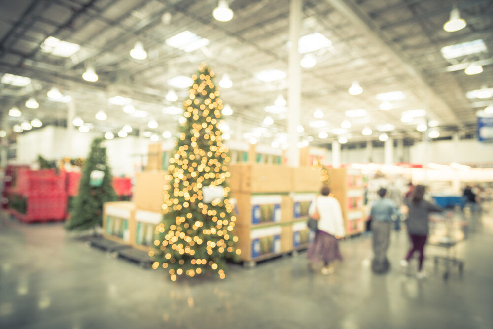 Blurred image huge Christmas tree decoration with people holiday shopping in wholesale store.