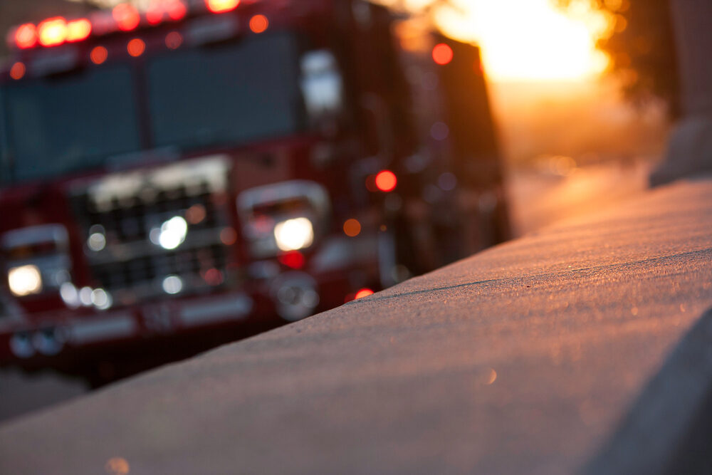 Single-Vehicle Crash on Myotis Dr near Duckhorn Dr in North Natomas, Sacramento blurred Fire truck pulls up to the scene of an accident at sunset