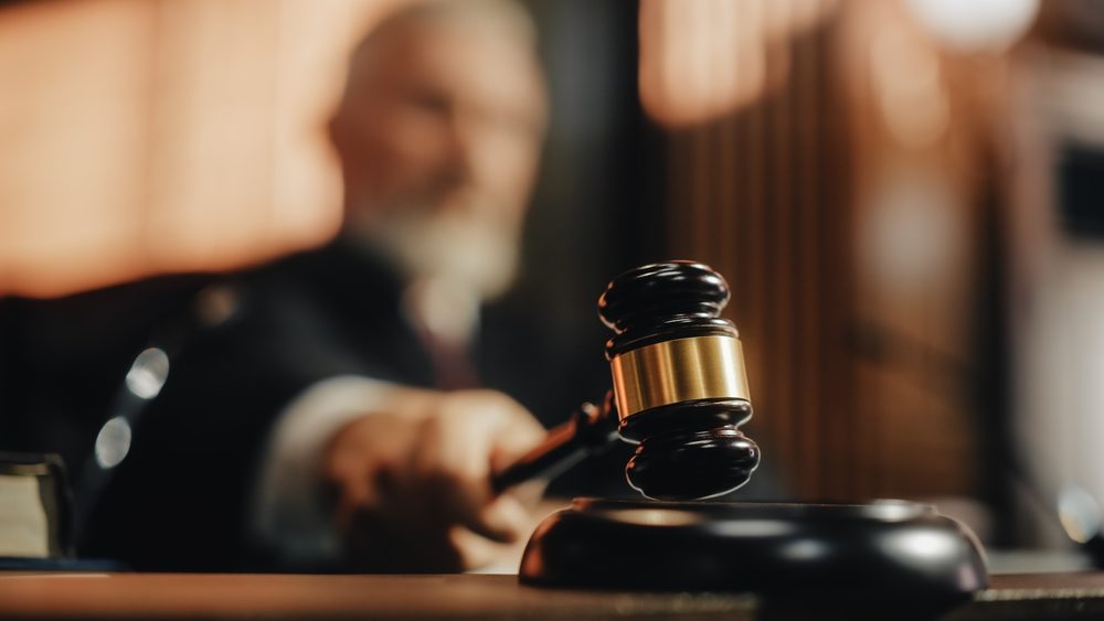 blurred image of judge striking his gavel