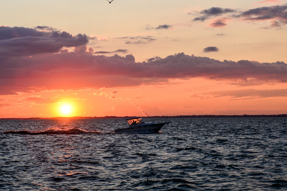 a boat crossing the sunset in Sandusky bay On Lake Erie