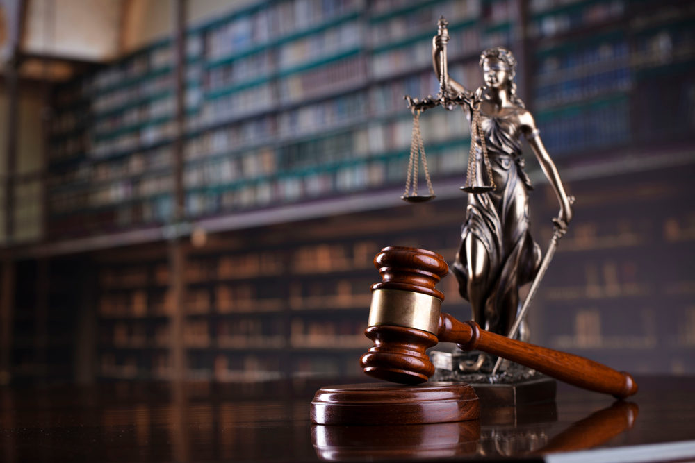 What Were You Reading About In 2020 At Legal Examiner? Judge's gavel on library background.