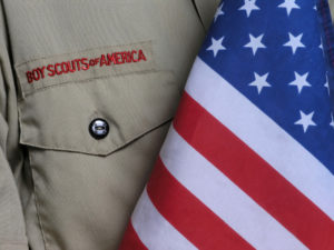 Boy Scouts of America shirt beside a US flag
