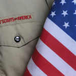 Boy Scouts of America shirt beside a US flag