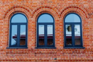 Minimalistic shot of a brick wall with windows.