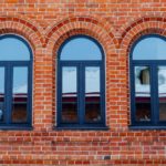 Minimalistic shot of a brick wall with windows.