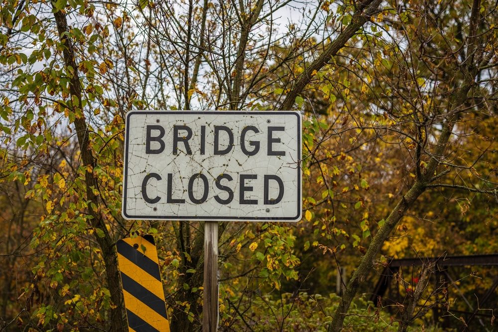 Sign indicating bridge ahead is closed.