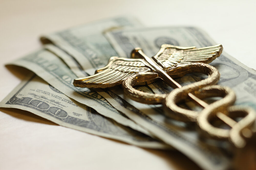 gold caduceus on 100 dollar us bills