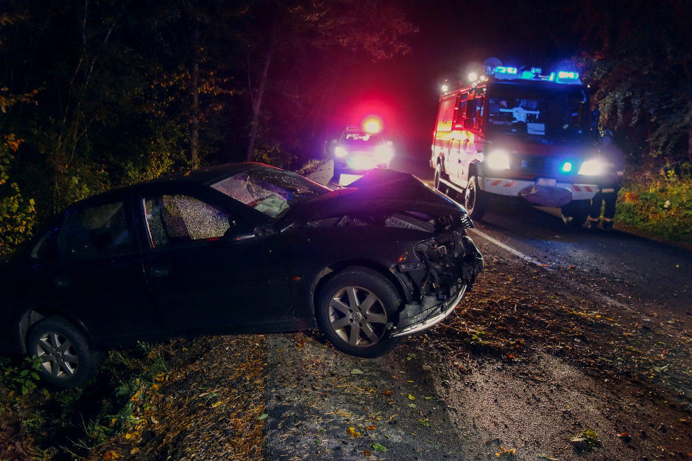 car crashed off roadway with police and emergency services.