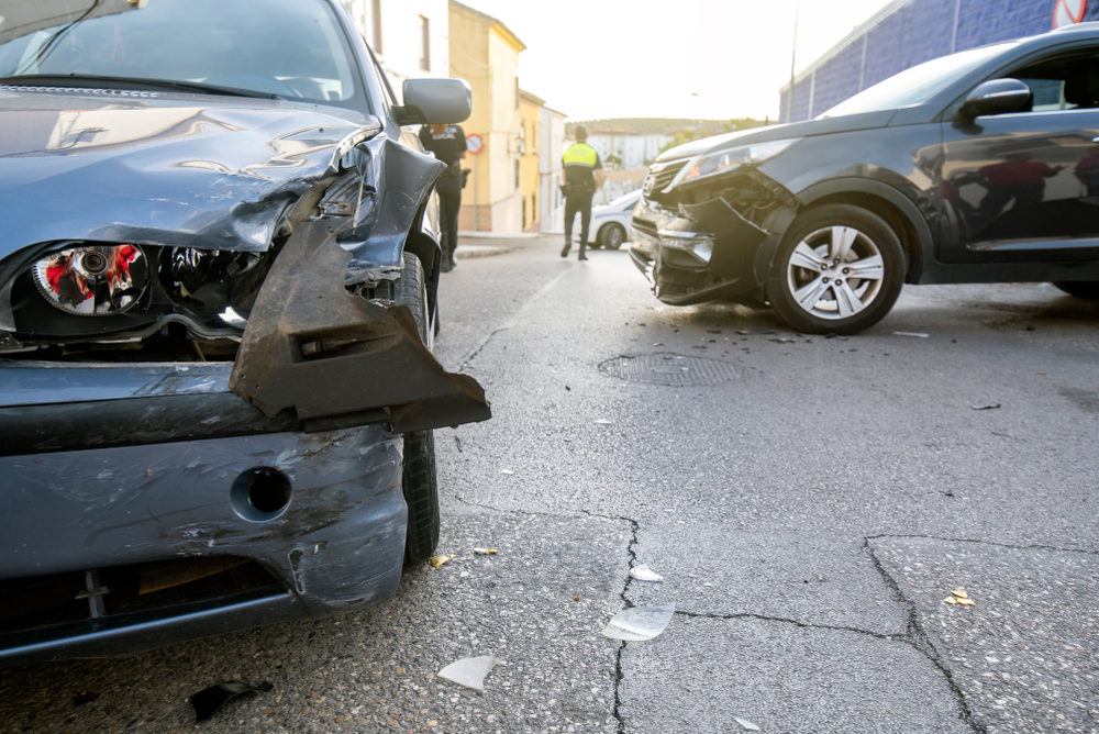 two cars after a collision on a roadway