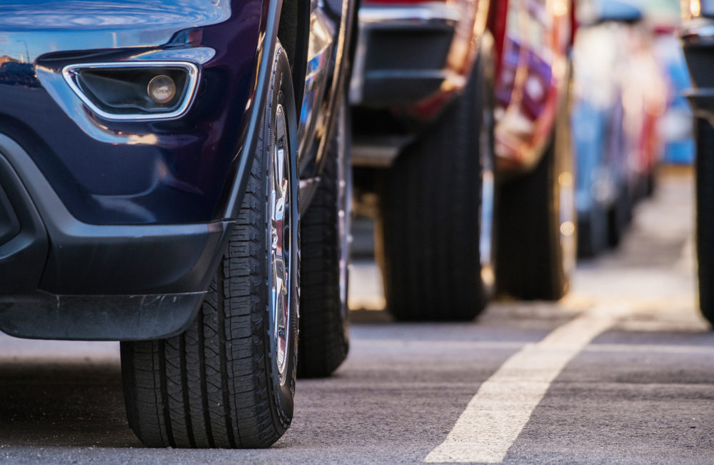 assorted color vehicles lined up with a view of tires