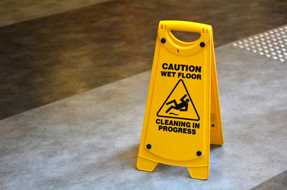 Slippery floor surface warning sign and symbol in building