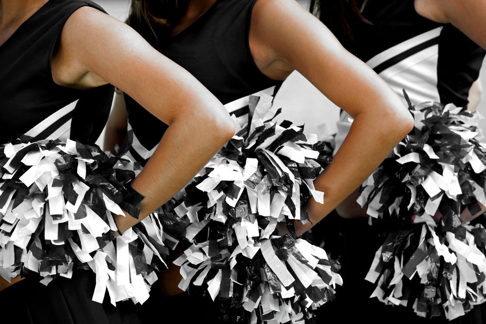 Cheerleaders in Uniform Holding Pom-Poms