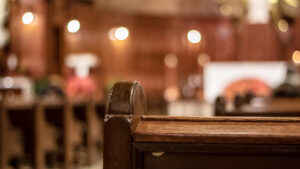 back view of an interior church pew with blurred background
