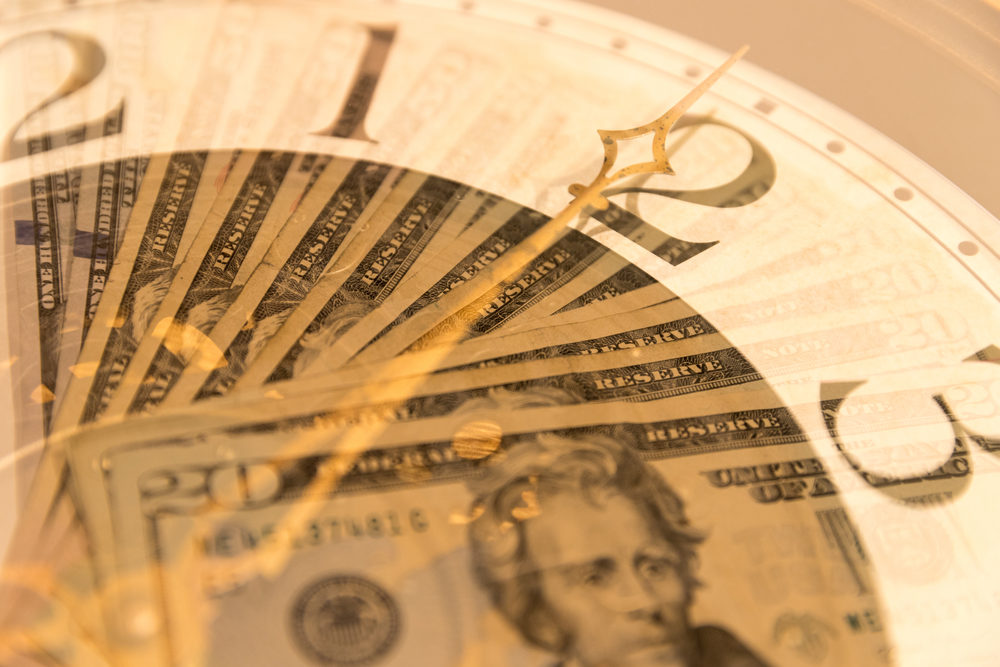 A clock with US currency bills double exposed.