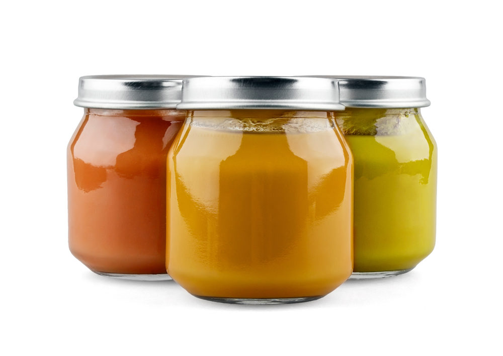 Three jars of baby food on white background