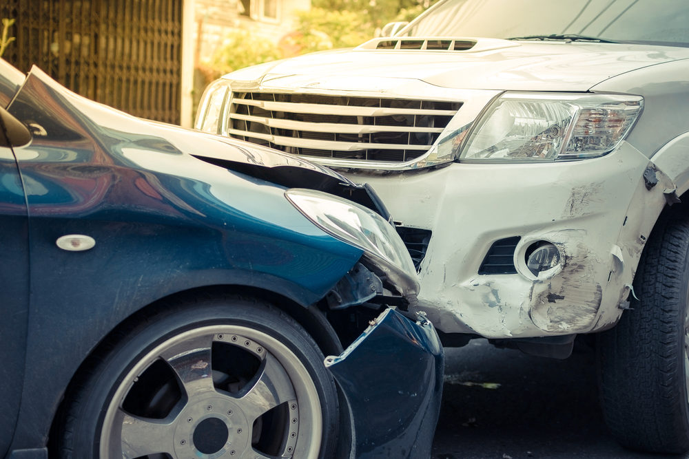 cloesup of two vehicles after a head on collision