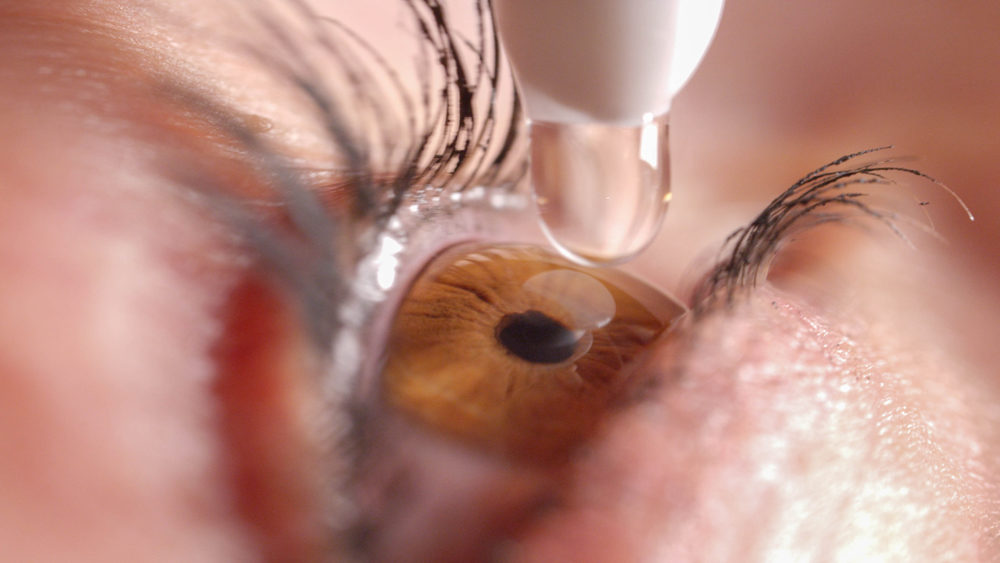closeup of eye drops being applied to pupil