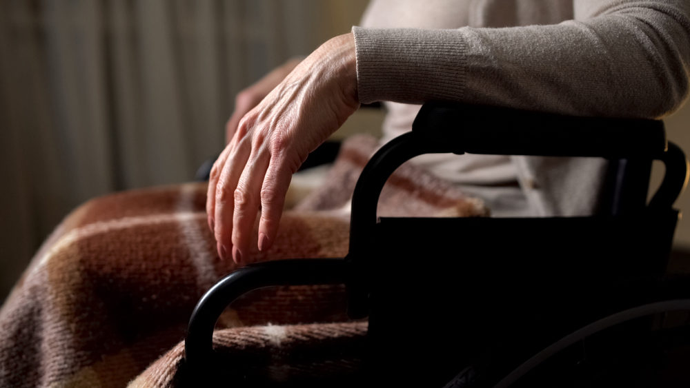 Lady with disabilities quietly sitting in wheelchair