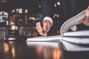 Close up lawyer businessman working or reading lawbook in office