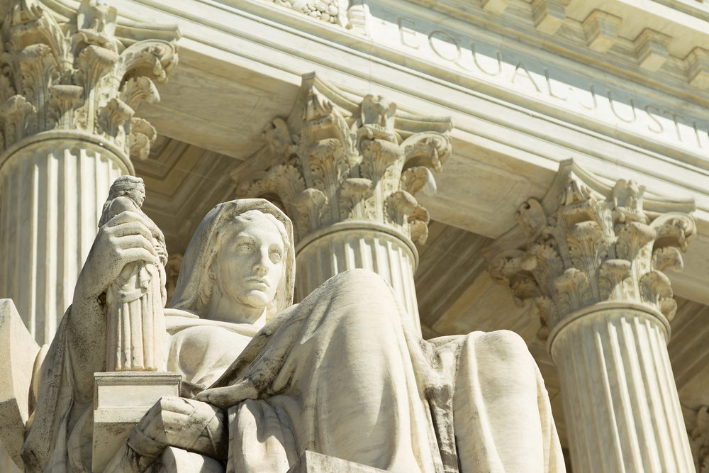 closeup of statue on the steps of the us supreme court