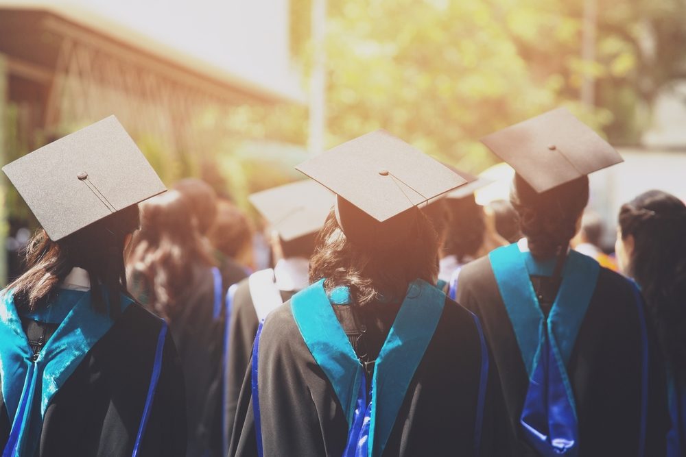 Rear view of robed students at a graduation ceremony