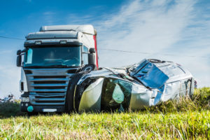 suv on side after collision with a semi truck