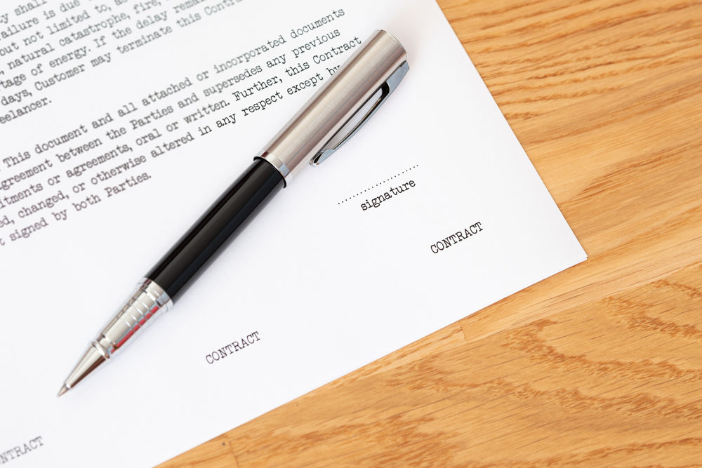 Signing contract document, letter, agreement with a ball point pen