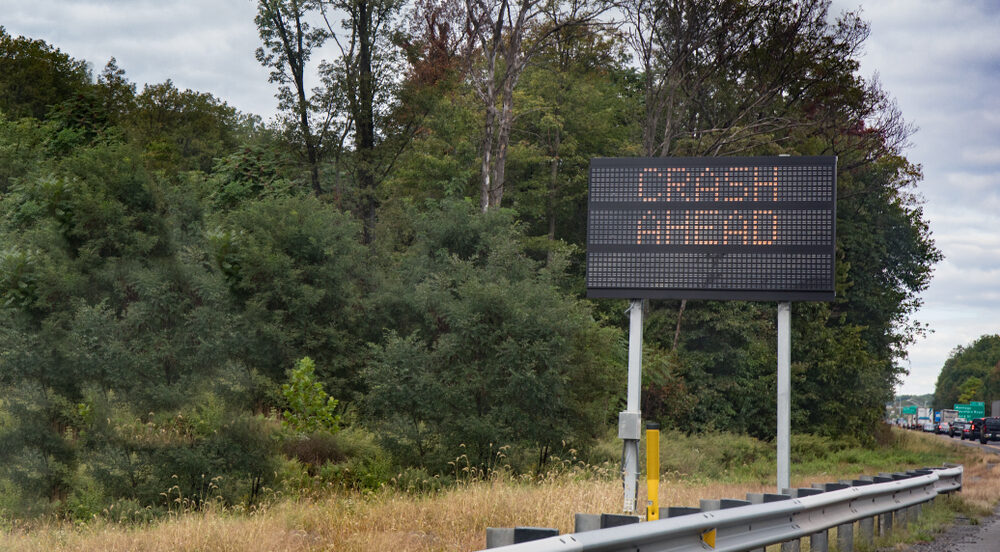 Flatbed Trailer Detaches from Truck, Sparks Multi-Vehicle Collision on Route 9 South in Sayreville, NJ Killing One Man An electric sign warning motorists of a crash ahead with traffic backed up.
