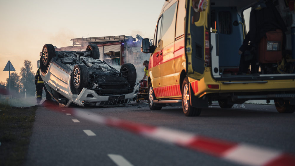 New Lancet Series Highlights Steps Countries Can Take to Improve Global Road Safety Accident Scene Rollover Smoking Vehicle Lying on its Roof in the Middle of the Road after Collision.