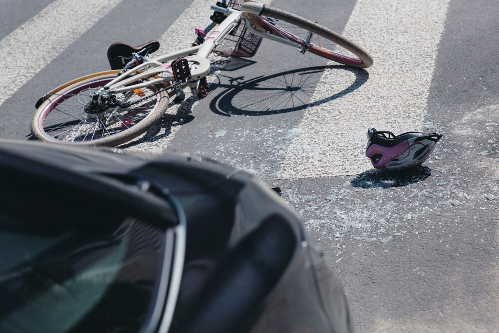 Helmet and bicycle on a crosswalk after collision with a car
