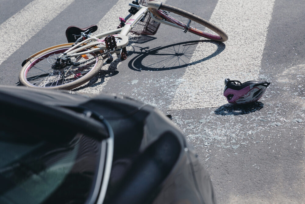 San Francisco Bay Area Bicycle Accidents with Uber and Lyft Drivers Helmet and bicycle on a crosswalk after collision with a car