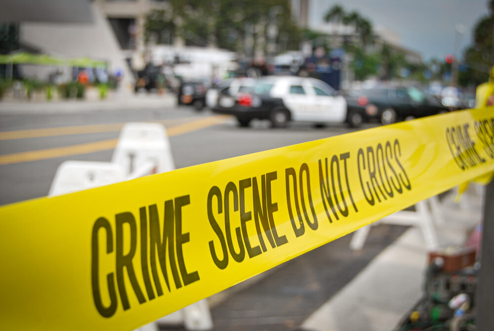 crime scene tape around an auto accident barricade