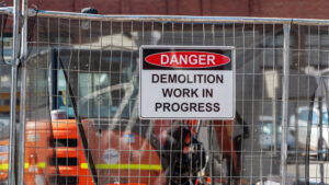 Danger, demolition work in progress sign at a construction site.